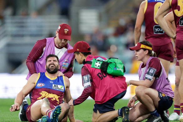 Marcus Adams pictured being assisted by trainers during round 21 last season.