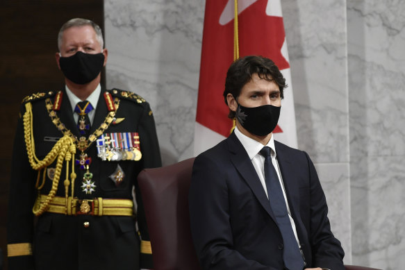 Canadian Chief of Defence Staff Jonathan Vance (left) and Prime Minister Justin Trudeau listen to Governor-General Julie Payette deliver the throne speech in the Senate chamber in Ottawa.