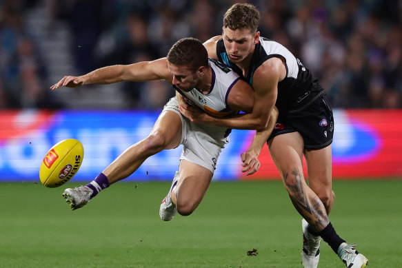 Sam Switkowski of the Dockers is tackled by Kane Farrell of the Power.