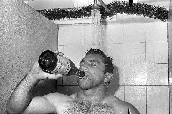 John Sattler enjoys some champagne in the shower after his courageous performance in the 1970 grand final.