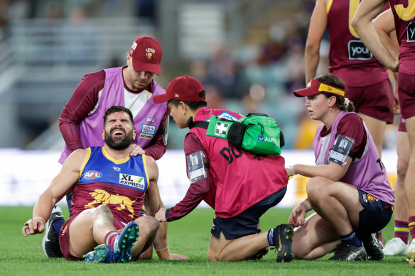 Marcus Adams pictured being assisted by trainers during round 21 last season.