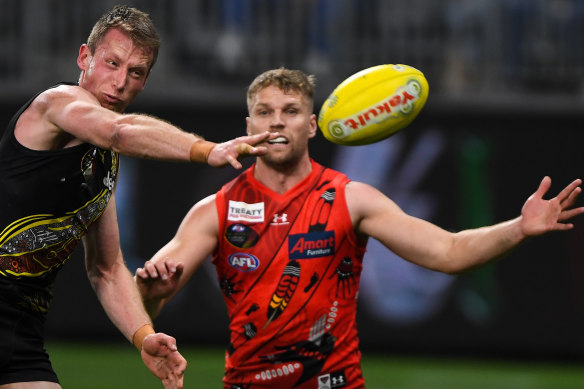 Dylan Grimes slaps the ball away from Jake Stringer last year.