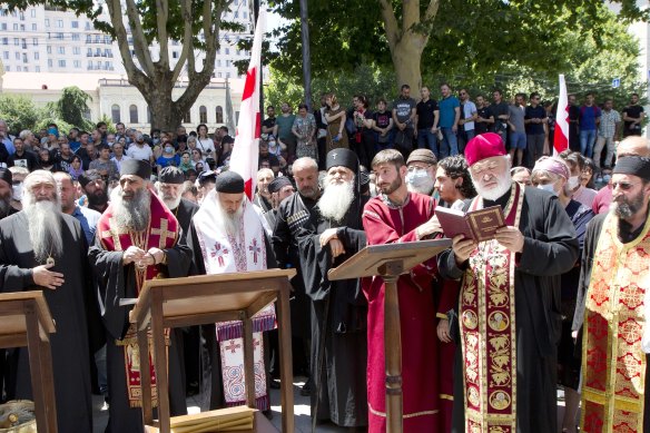 Georgian Orthodox priests who opposed the march lead prayers after blocking the capital’s main avenue to an LGBT march.