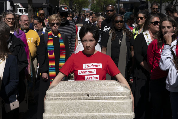 Shannon Felder holds a child’s casket before a march to the state Capitol to protest gun violence during a Tennessee Moral Monday rally in Nashville on Monday.