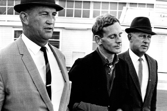 “Long Bay gaol escapee Ralph Barnes being escorted by detectives on his arrival from Melbourne Wednesday afternoon.”