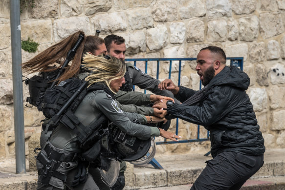 Members of the IDF scuffle with a Palestinian man at a checkpoint near Lion’s Gate to enter the Al-Aqsa Mosque compound last month.