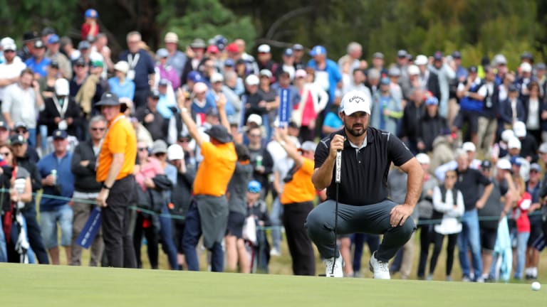 Lining up: Roberto Diaz of Mexico ponders a putt on the 17th in front of a large gallery.