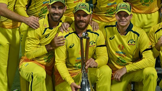 Glen Maxwell, captain Adam Finch and Steve Smith with the Chappell-Hadlee trophy in Cairns.