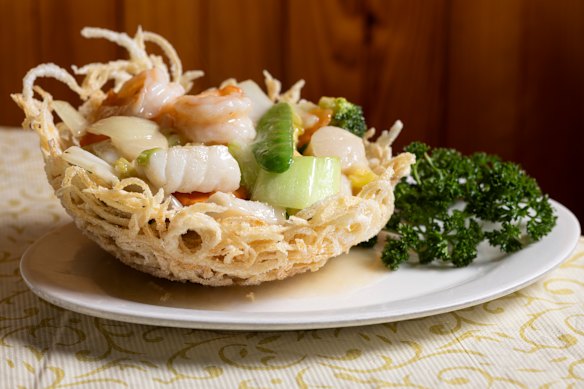 The signature seafood combination in bird's nest, served in a basket made from potatoes and filled with prawns, scallops and fish.