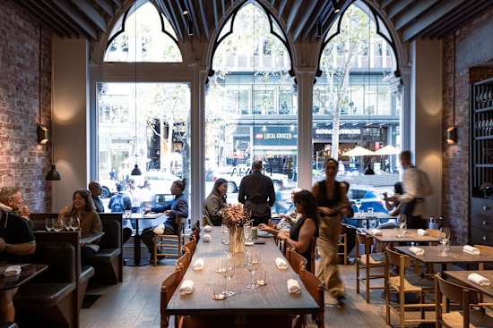 The dining room’s arched Gothic-style windows face Collins Street.