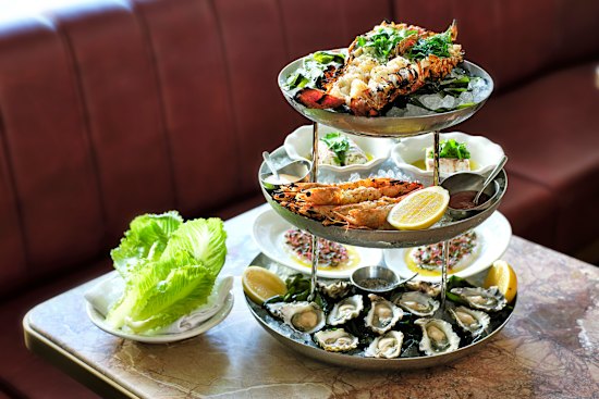 Plateau de fruits de mer features lobster, prawns and oysters.