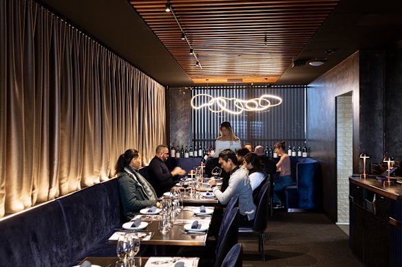 The fifth-floor restaurant is a chic, sleek, blue-velvet cave with lamp-lit tables.