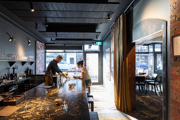 Awall separating the bar next door has been opened up, making the conjoined room more dynamic.