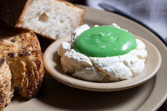 Tyga’s kaya toast is made with toasted sourdough (left), butter whipped with coconut custard, and a pool of pandan cream.