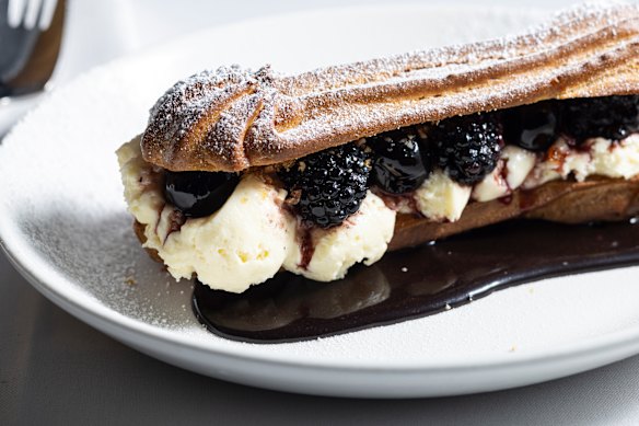 Bignè: a dressed-up eclair layered with cherries in syrup, white chocolate cream and blackberries.