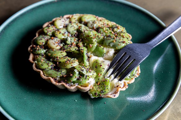 Duck-fat spanner crab tart filled with potato purée, crab mayonnaise and studded with broad beans.