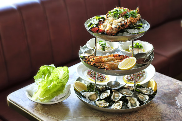 Plateau de fruits de mer features lobster, prawns and oysters.