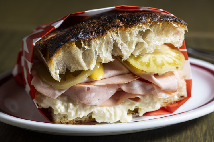 Mortadella, salami, milky-fresh cheese and green tomatoes in focaccia is available at lunch.