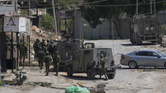 Israeli forces patrol a street during a military operation in the West Bank refugee camp of Al-Faraa.
