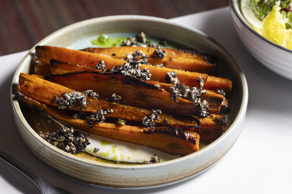 Wood-fired carrots tossed with seeds and herb oil.