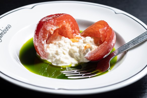 The tomato is stuffed with stracciatella.