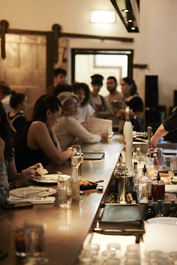 Take a seat at the moody bar.