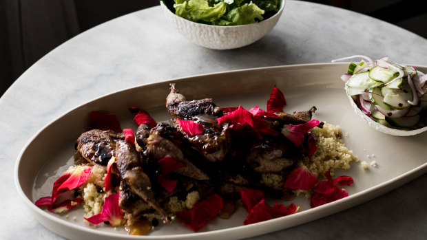 Quail with cous cous, rose petals and cucumber salad.