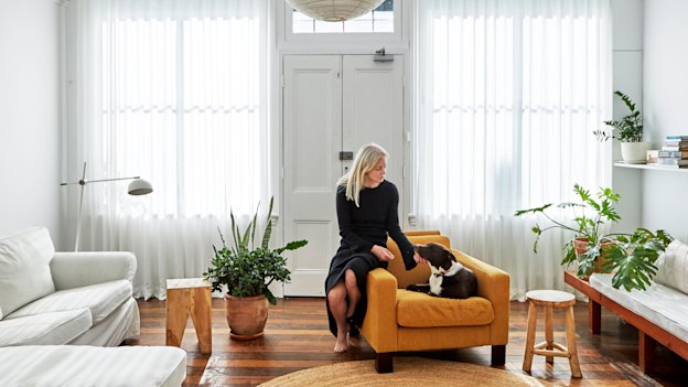 Cynthia describes the front room as “a versatile space that I can convert into a gallery when I have exhibitions”. The wooden stools are from InArtisan and the light shade is from The Society Inc.