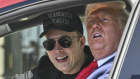 President Donald Trump and Tesla CEO Elon Musk speak to reporters as they sit in a Tesla vehicle on the South Lawn of the White House on Tuesday.