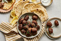 Beef koftas with pita bread and minted yoghurt.