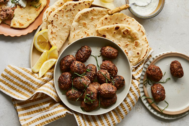 Beef koftas with pita bread and minted yoghurt.