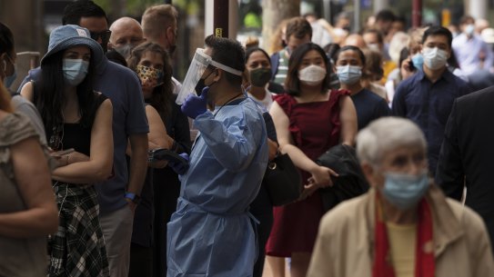 A 300 metre queue of people wait for COVID testing at the Macquarie St Pharmacy. Street Pharmacy as cases hit record highs today. The wait is currently over two hours for a test. 16 December, 2021. Photo: Brook Mitchell