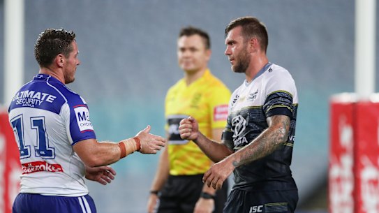 Bulldogs captain Josh Jackson goes to shake hands with Kyle Feldt but the Cowboys winger opts for a safer approach.