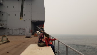 The evacuation begins on HMAS Choules.