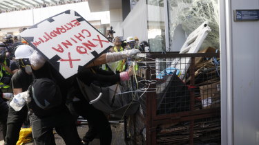 A small number of violent protesters rammed a metal cart through a window of the Hong Kong Legislative Council.