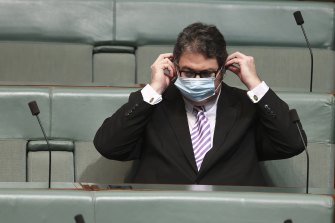 Nationals MP George Christensen removes his mask in order to share his view about how masks donâ€™t work.