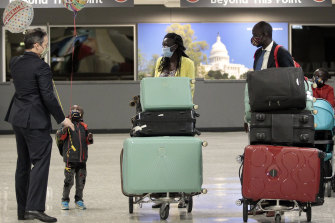 Lawyer Jared Genser, left, greets Baraka Ajak, second from left, wife Nyathon Hoth Mai, Peter Biar Ajak and Deng Ajak, right, on arrival in the US.