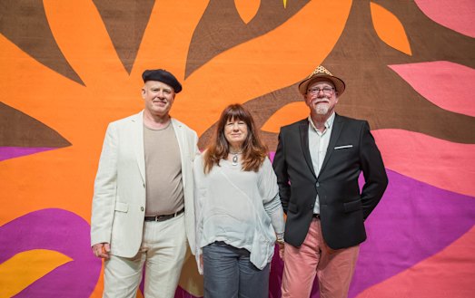 Daniel Coburn, Kristin Coburn and Stephen Coburn in front of their father's Curtain Of The Sun. 