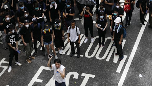 Roy Kwong, legislator and member of the Democratic Party, bottom, speaks during a demonstration on June 21.
