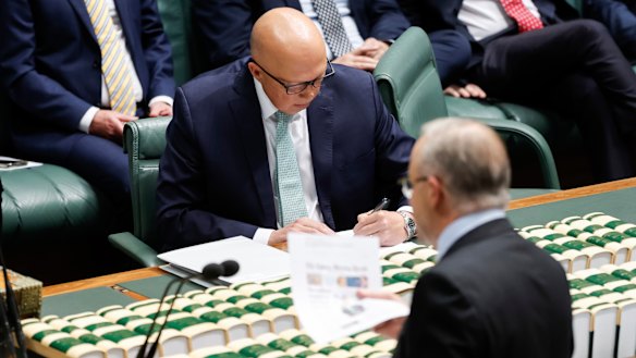 Prime Minister Anthony Albanese waves a printout of The Sydney Morning Herald’s September 12 front page on No’s campaign tactics.