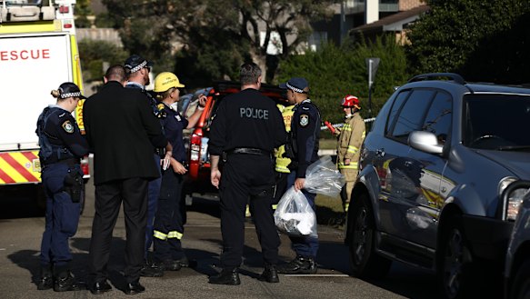 Fire crews and investigators attend the scene in Putney. 