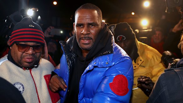 R. Kelly turns himself in at a Chicago police station after being charged with sexual abuse.