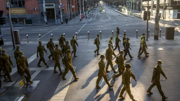 Australian Defence Force personnel and police at Southern Cross Station in Melbourne on Sunday, ready to enforce Melbourne's strict new lockdown rules. 