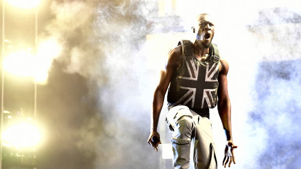 Stormzy performs at Glastonbury wearing the iconic stab-proof vest gifted him by Banksy.
