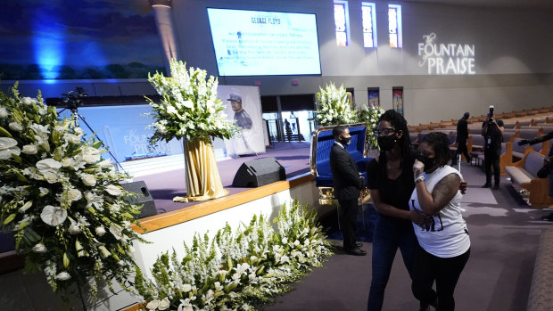 Mourners pass by the casket of George Floyd during a public visitation for Floyd at the Fountain of Praise church on Monday.