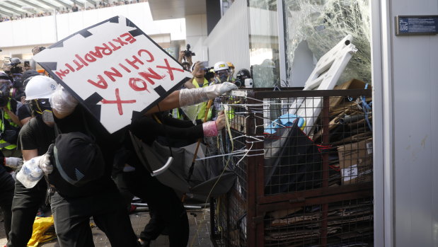 A small number of violent protesters rammed a metal cart through a window of the Hong Kong Legislative Council.