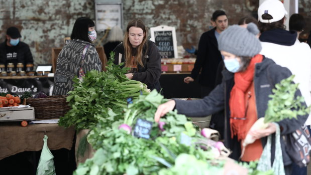 About half of shoppers and stallholders wore face masks at Carriageworks Farmers Markets, which reopened Saturday.