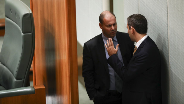 Environment and Energy Minister Josh Frydenberg and Labor finance spokesman Jim Chalmers chat during Question Time.