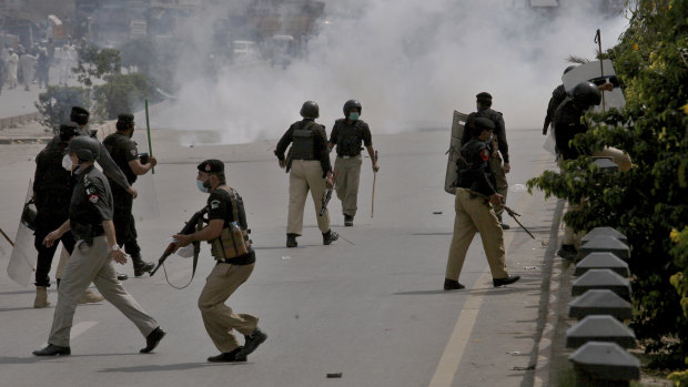 Police fire tear gas to disperse angry supporters of Tehreek-e-Labiak Pakistan, a radical Islamist political party, protesting against the arrest of their party leader, Saad Rizvi, in Peshawar, Pakistan.