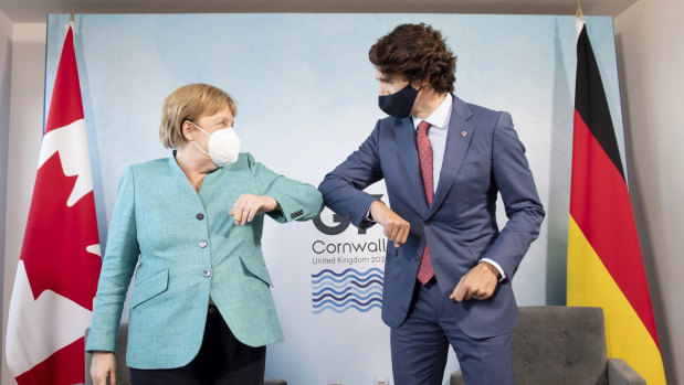 Elbow bumps not conferring gravitas:  Canadian Prime Minister Justin Trudeau welcomes German Chancellor Angela Merkel at the start of a bilateral meeting at the G7 Summit in Cornwall.